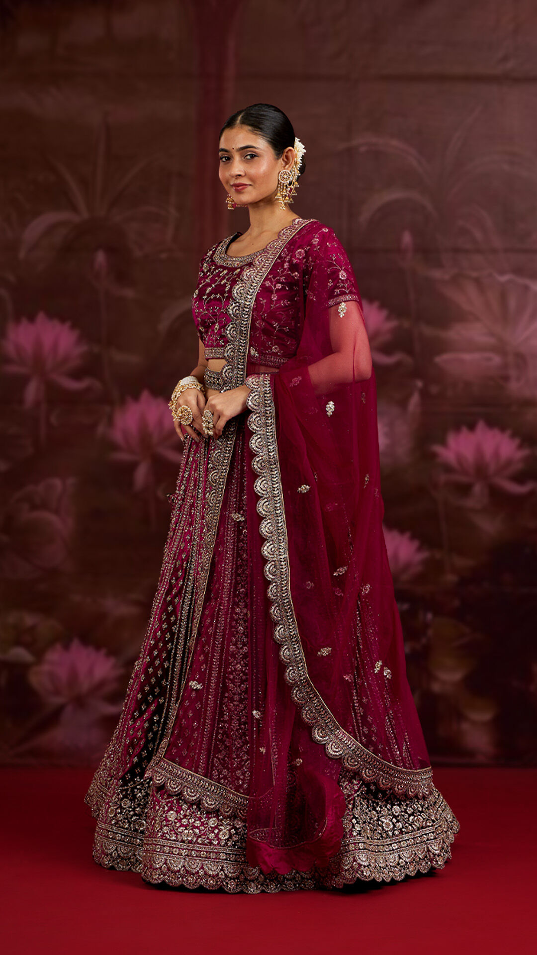 Woman gracefully wearing a silk red lehenga, a perfect choice for winter wedding elegance.